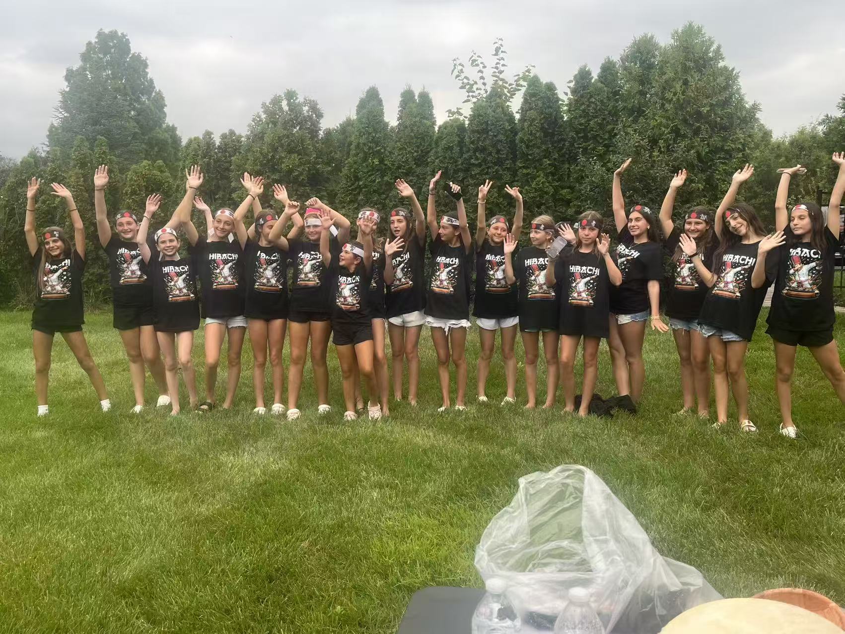 Group of happy guests in matching Hibachi t-shirts and headbands